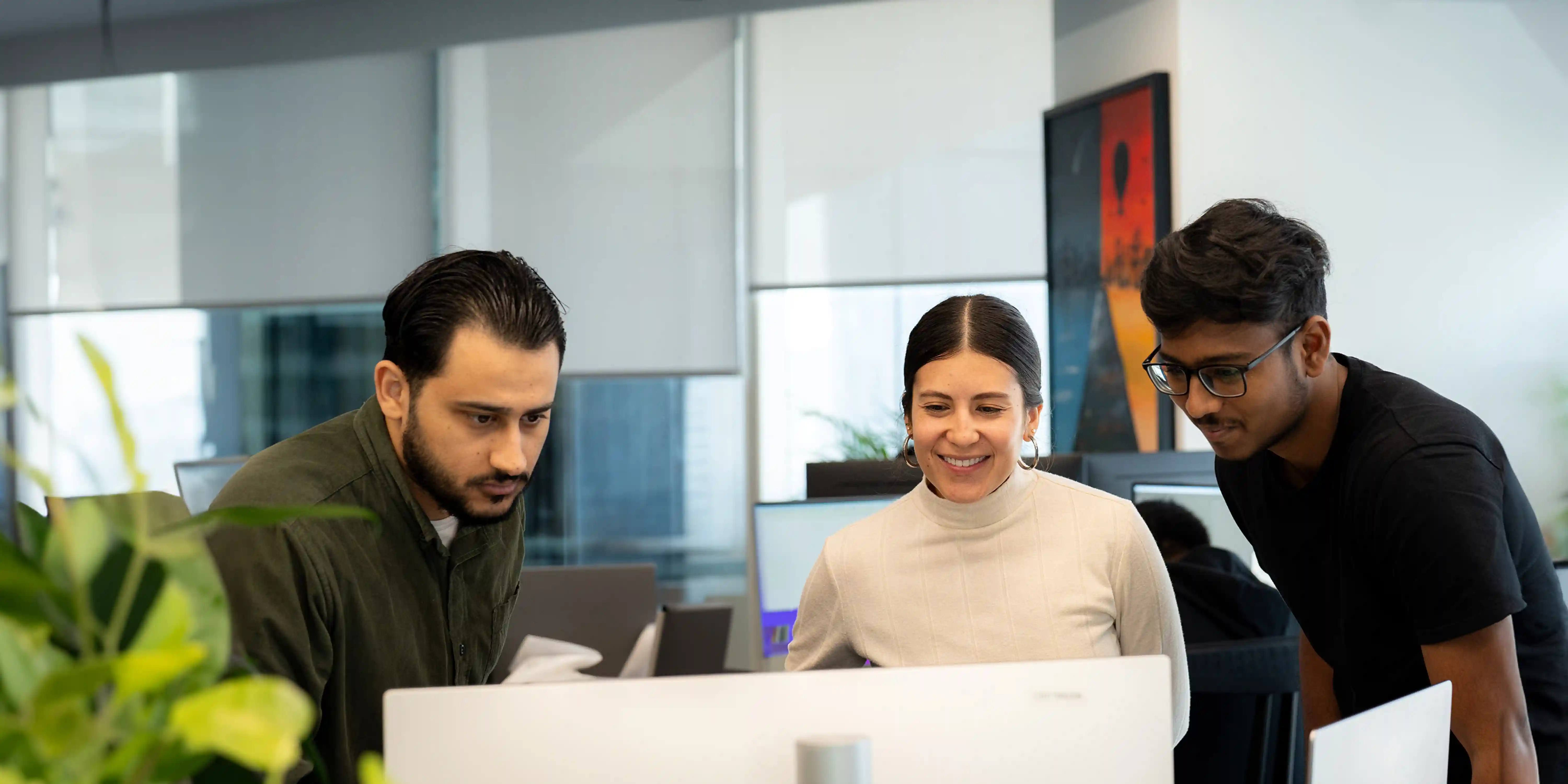 Deriv staff working together in a modern Dubai tech hub, showcasing company culture