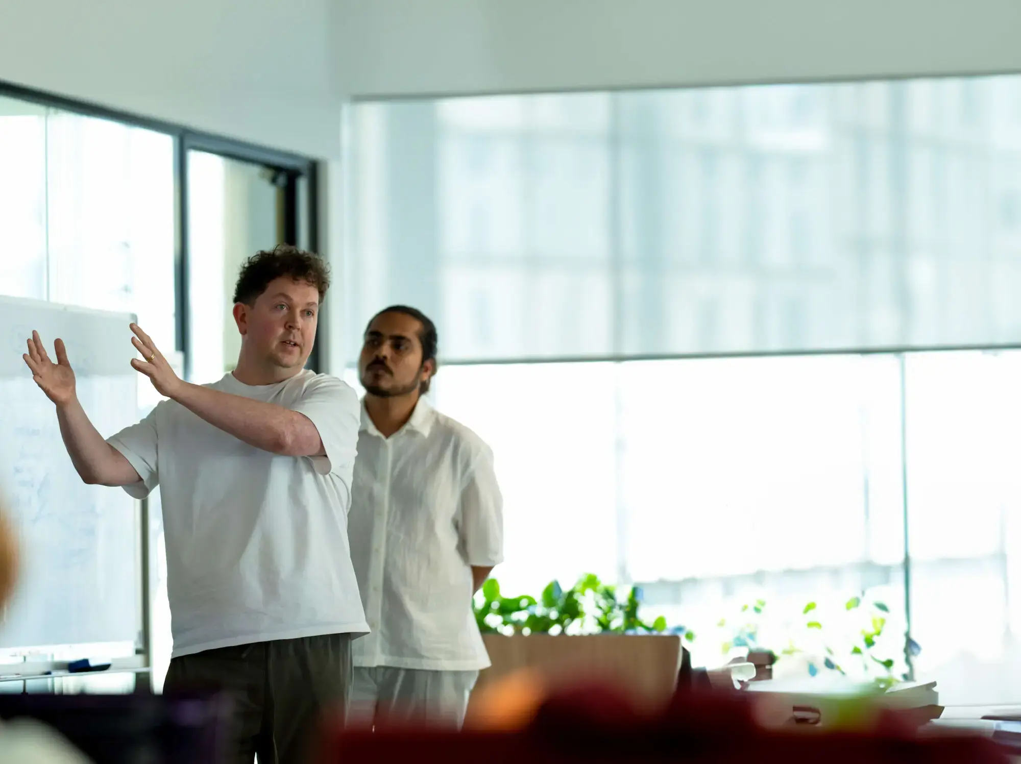 Candid moment of Deriv Dubai team during a project discussion in a collaborative workspace
