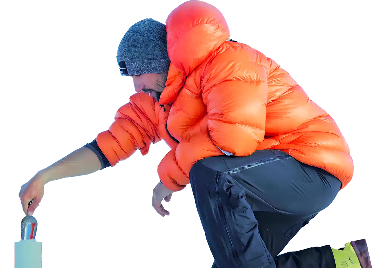 Person in orange jacket conducting fieldwork in icy terrain, symbolizing Deriv's hands-on approach to global CSR challenges.
