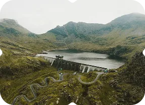 An aerial view of a winding road in the mountains.