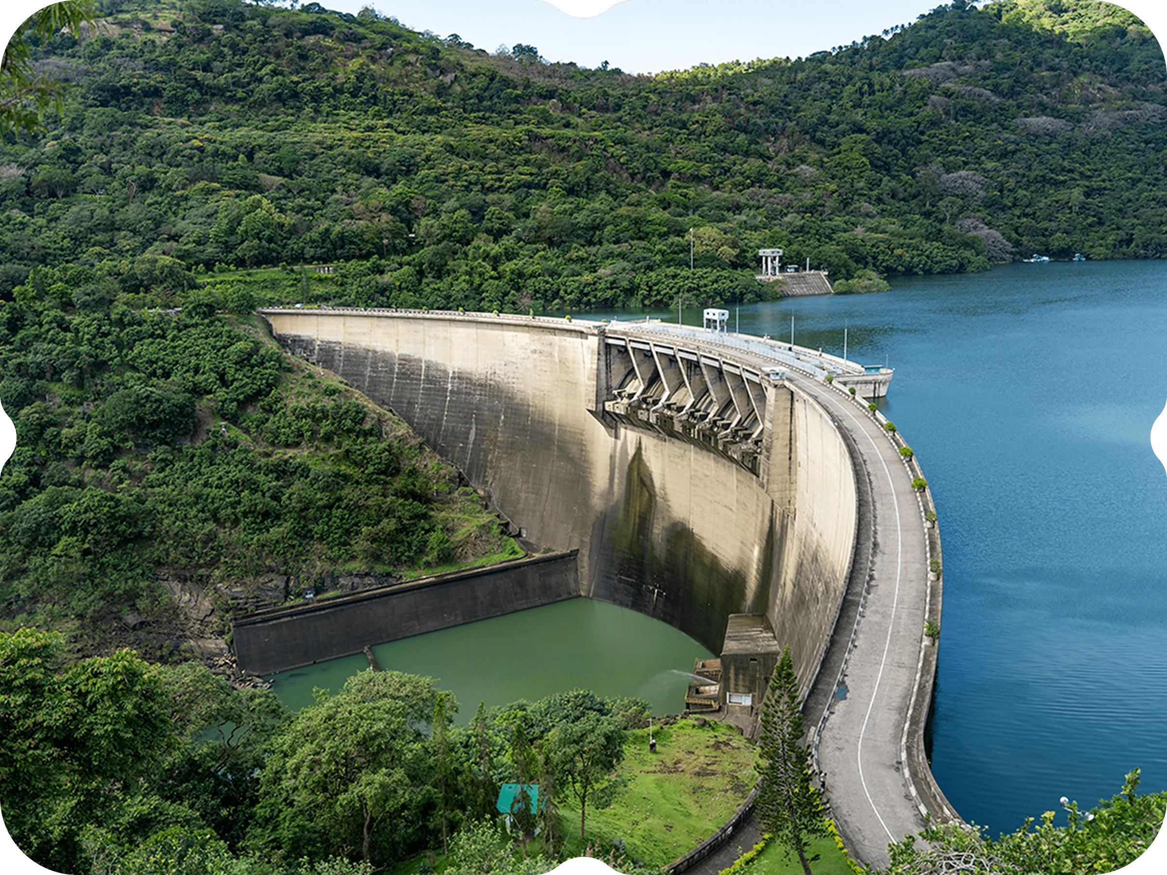 A view of a large dam with a lake below.