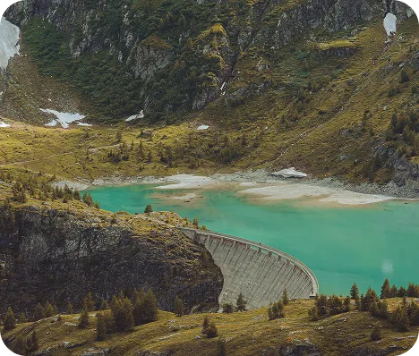 A large lake surrounded by mountains and trees.