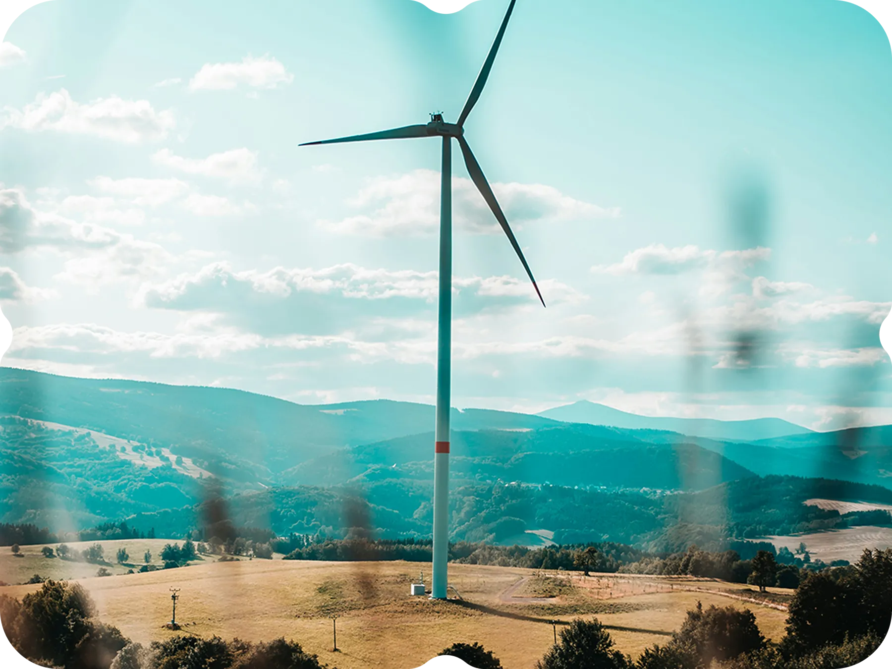A view of a wind turbine from a distance.