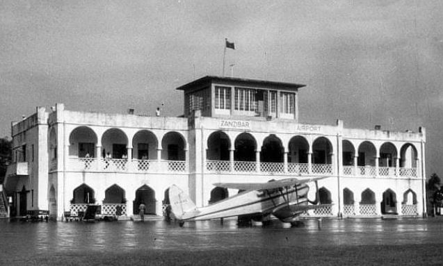 Archival photograph of the Zanzibar airport building with an aircraft in front