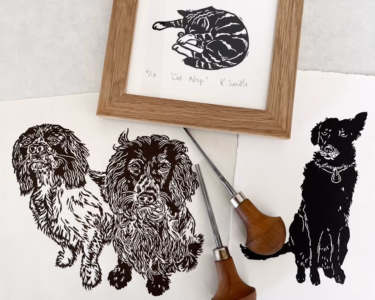 Linocut prints of dogs and a cat