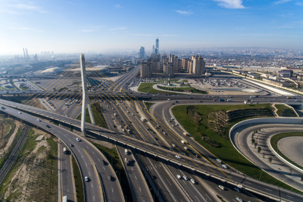 Aerial view of a multi-lane highway interchange and city.