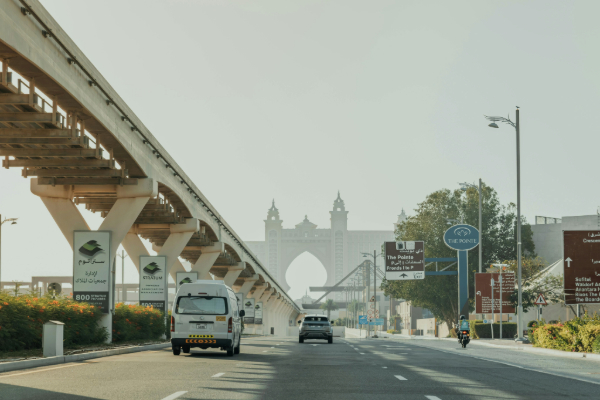 Monorail track leading to Atlantis The Palm in Dubai, with Palm Jumeirah Road and modern architecture along a scenic drive