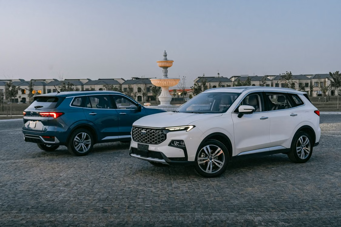 Two modern Cars parked in a plaza