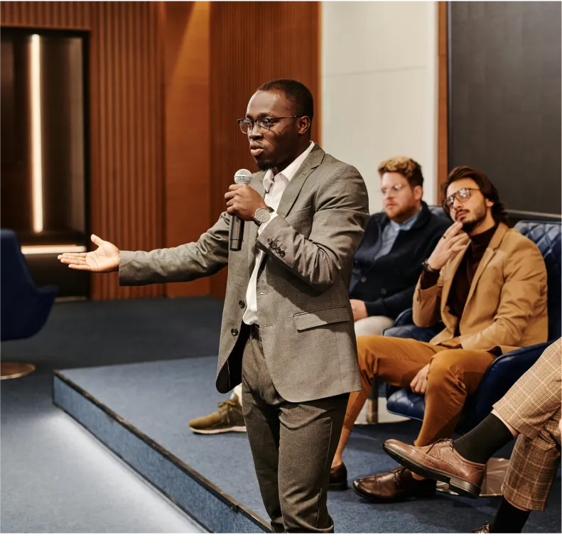 A man in a suit giving a speech.