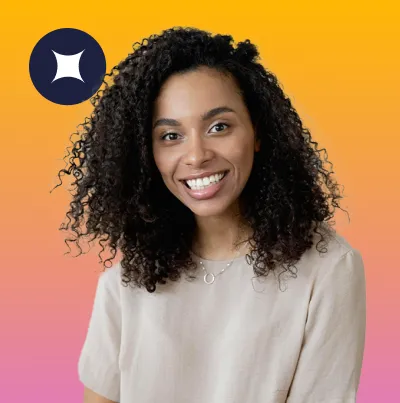 Smiling woman with curly hair wearing a light beige shirt against a yellow to pink gradient background.