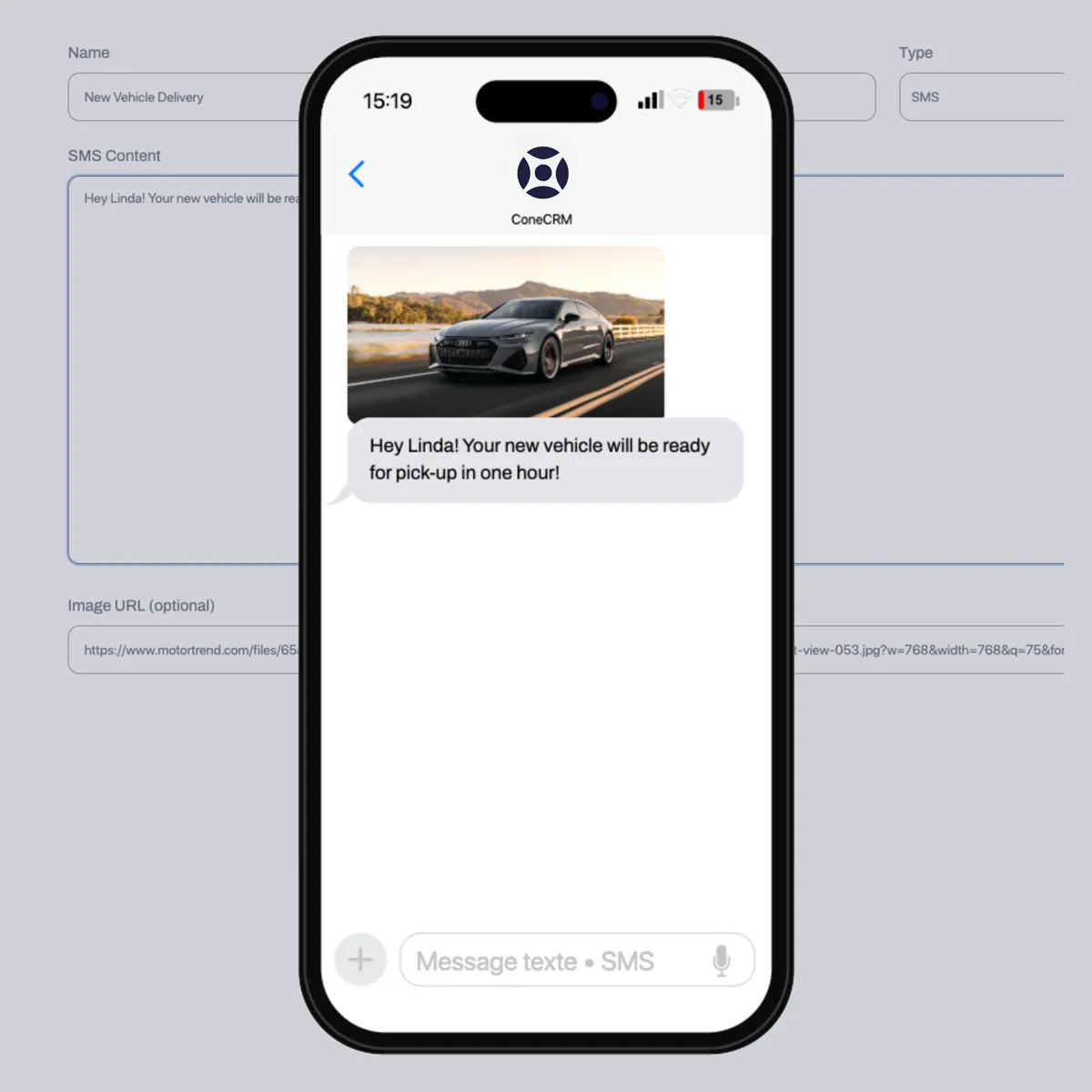 Smartphone screen showing a text message from ConeCRM with a photo of a gray car on a road and message saying vehicle will be ready for pick-up in one hour.