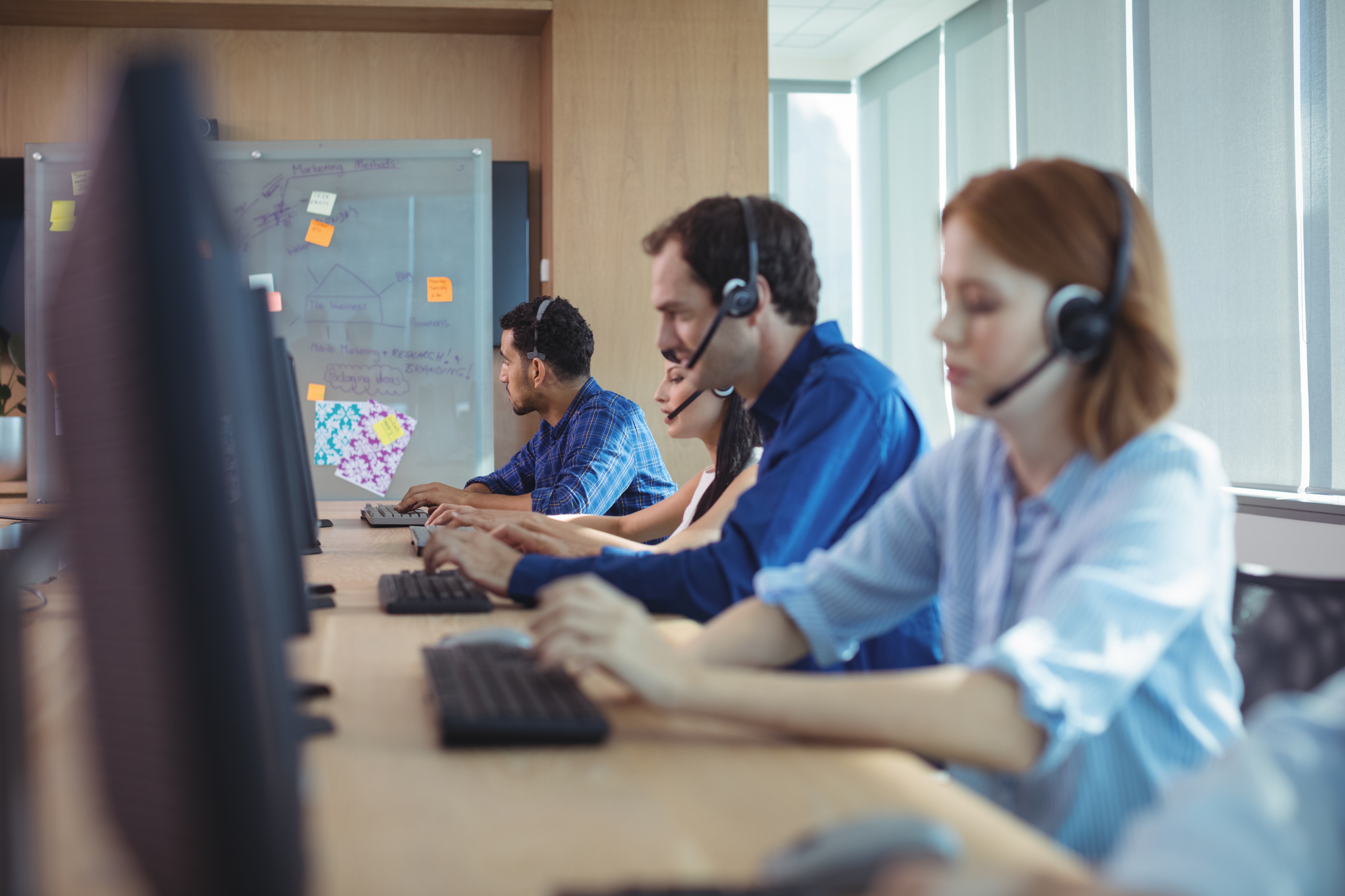 LEC contact center team working at their desks