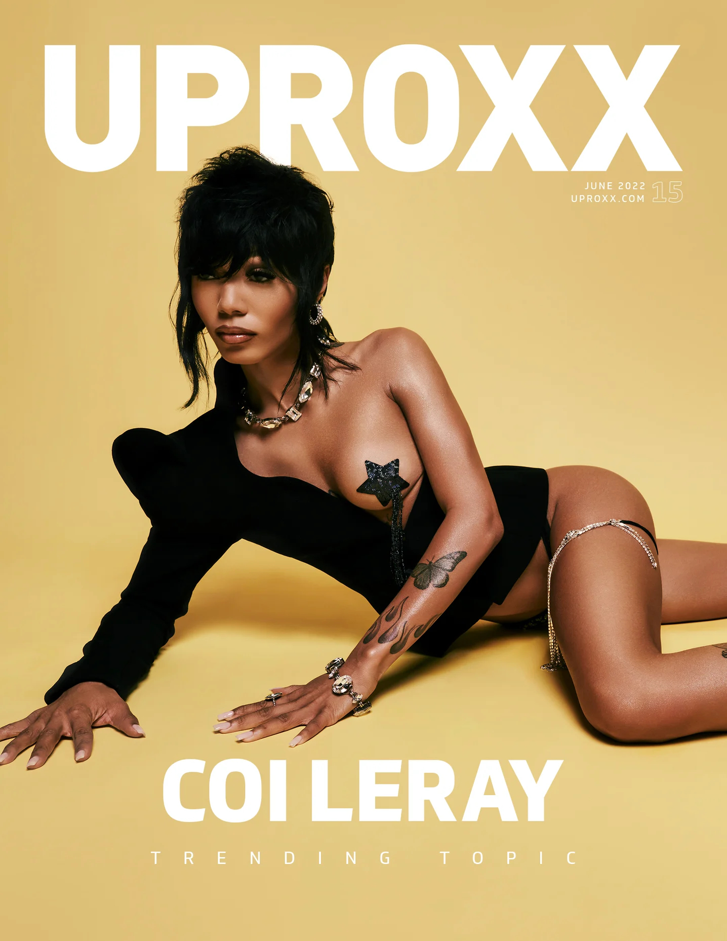 Coi Leray on UPROXX magazine cover, June 2022, posing in black outfit against gold background