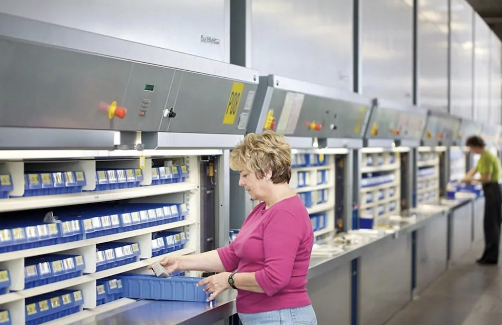 woman working at a horizontal warehouse carousel