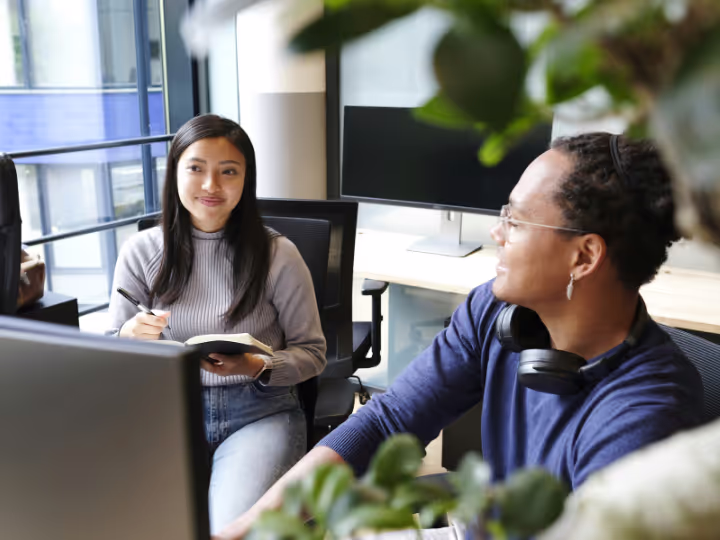 Coworkers smiling at each other