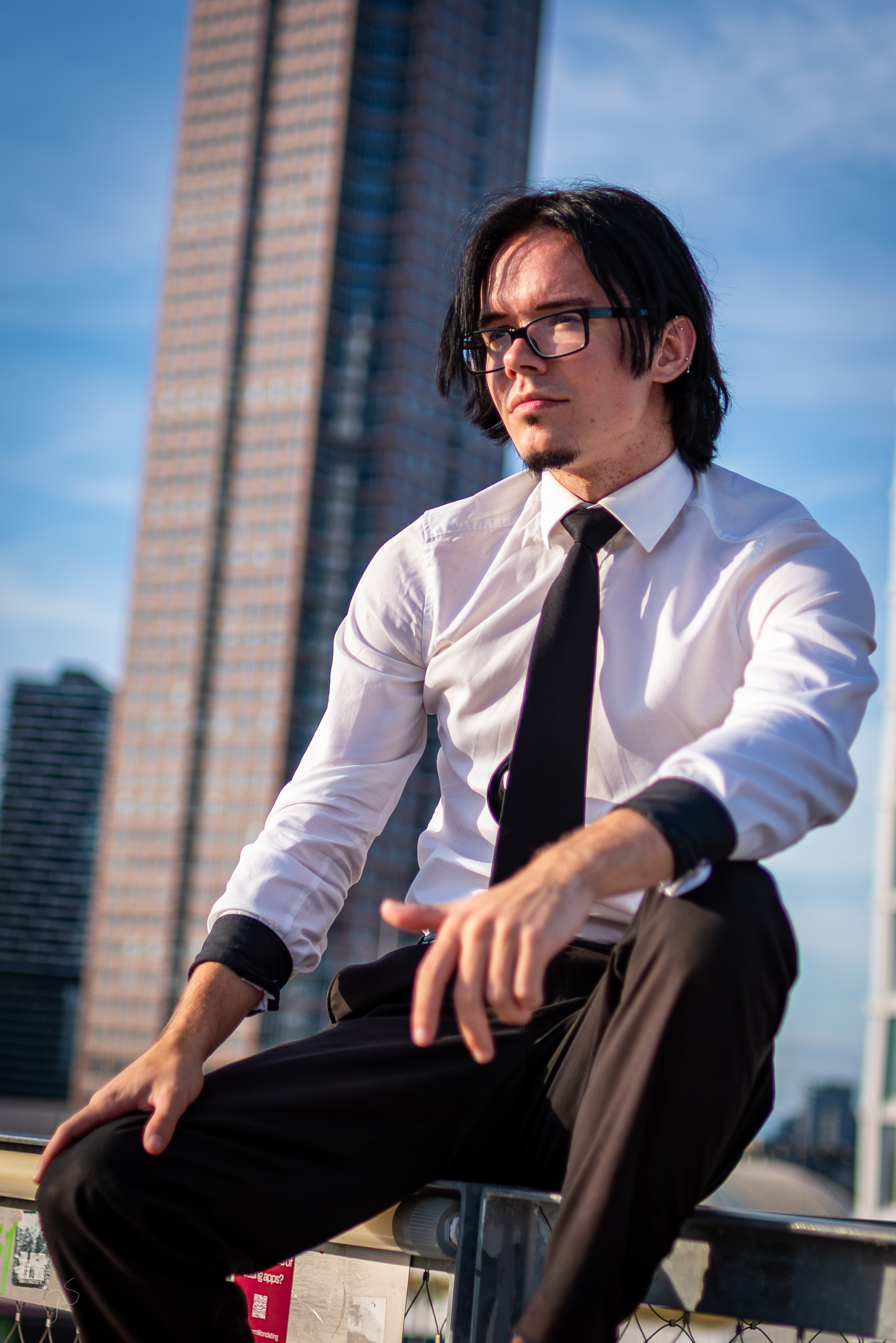 Ulyana, a realism and anime tattoo specialist at Woof Tattoo Frankfurt, posing in a creative studio setting.