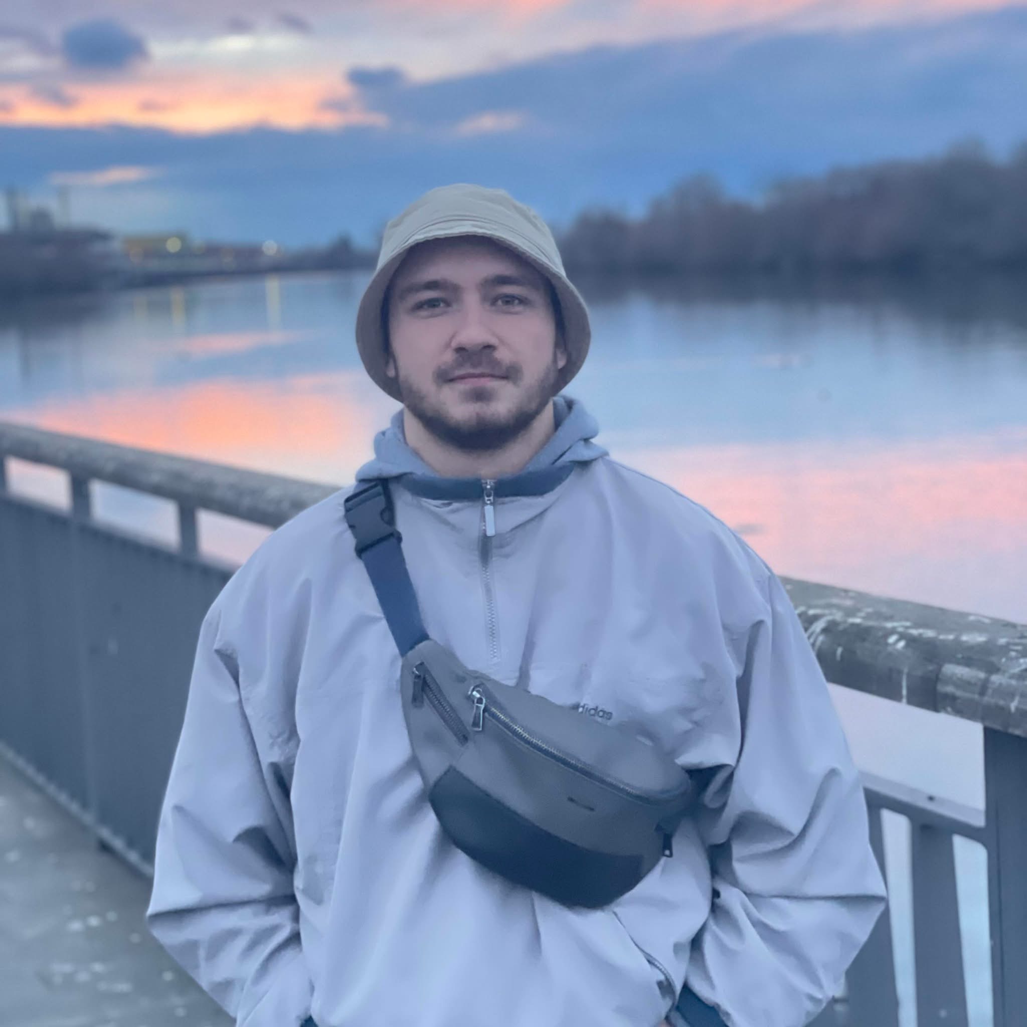 Ulyana, a realism and anime tattoo specialist at Woof Tattoo Frankfurt, posing in a creative studio setting.