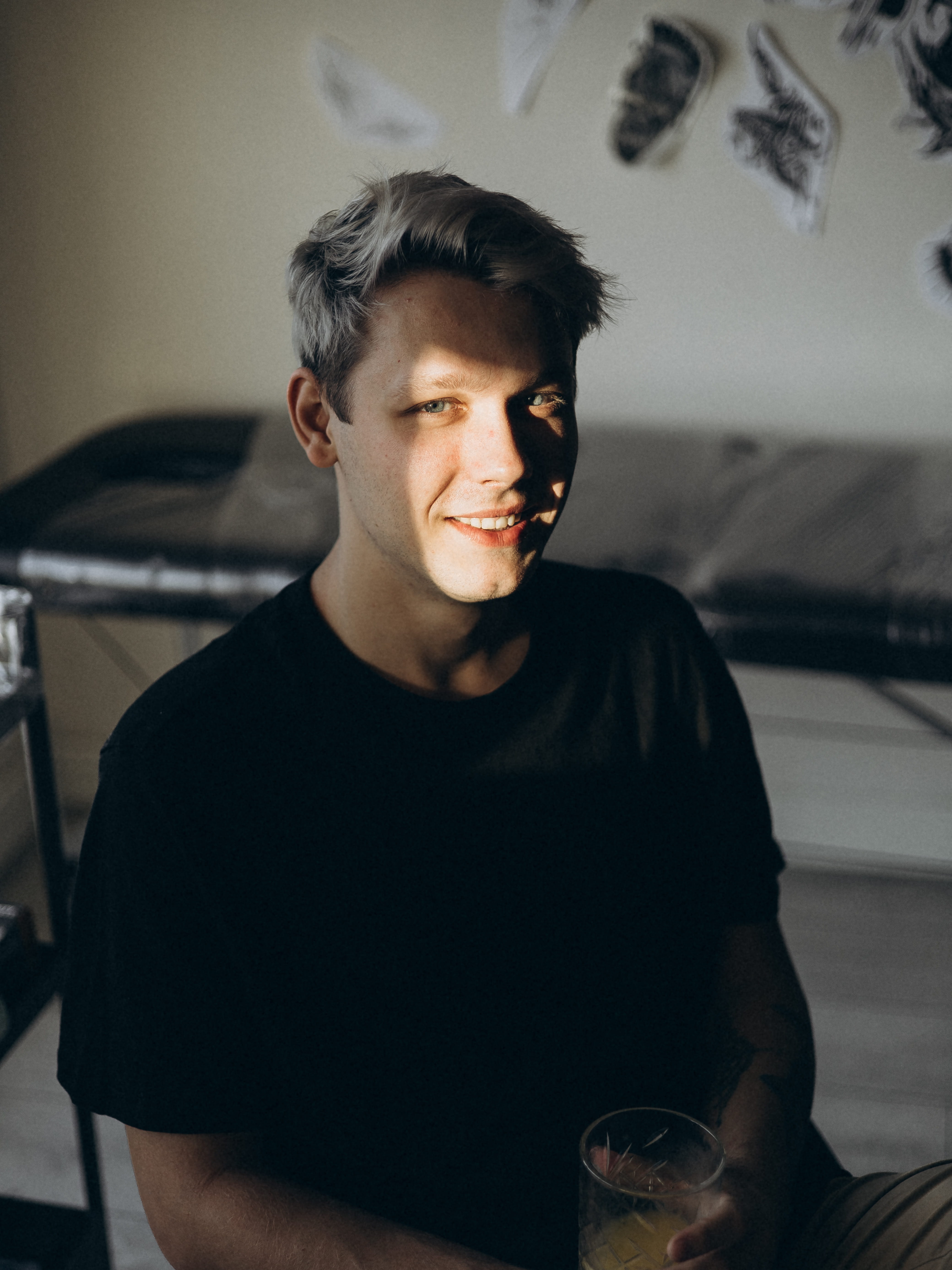 Ulyana, a realism and anime tattoo specialist at Woof Tattoo Frankfurt, posing in a creative studio setting.