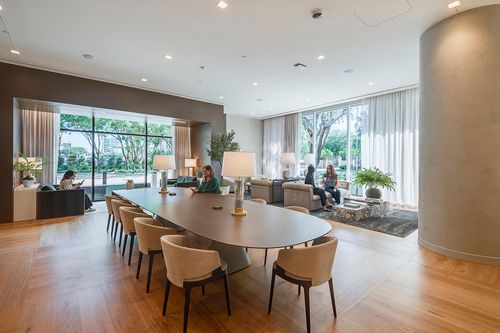 large table and breakout seating in office lobby