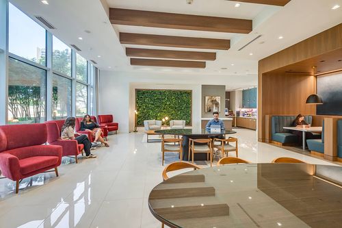 large tenant lounge with windows, soft seating and tables