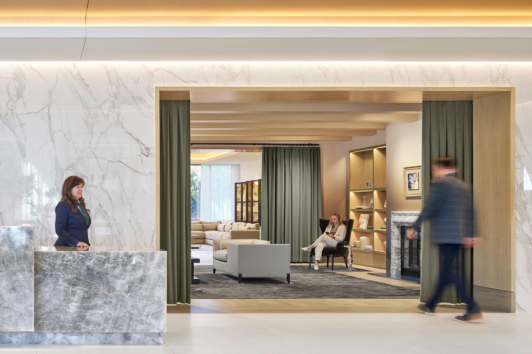 Reception space in lobby showing breakout seating and a library peaking behind.