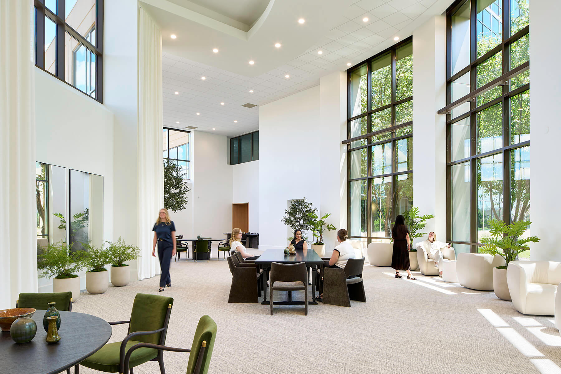 Double height lobby with large windows and multiple breakout seating.