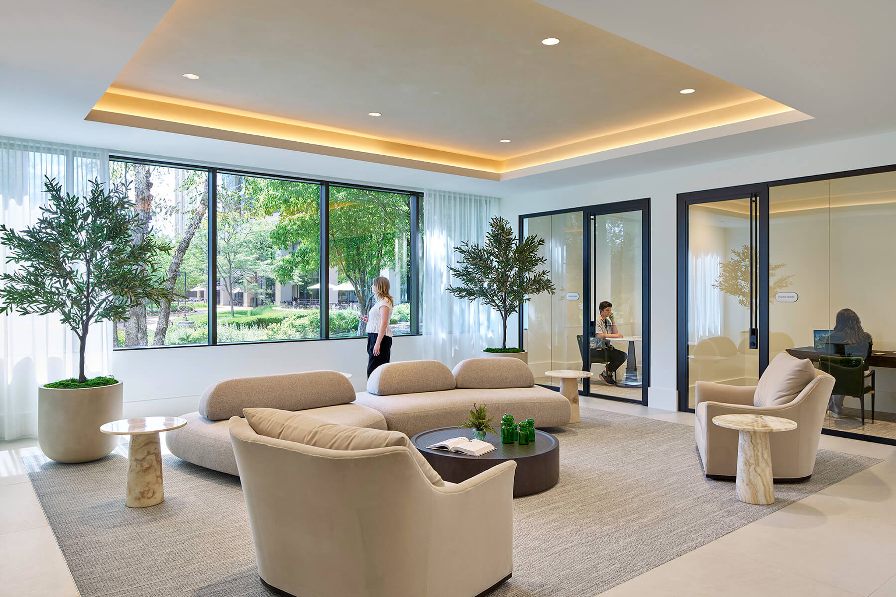 Breakout seating and couches in the lobby entrance with large windows and bright lighting.