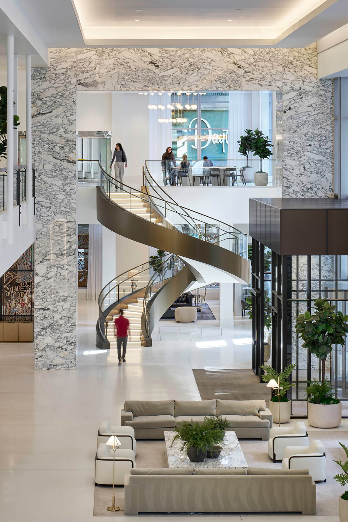 Two story spiral staircase in lobby entrance.