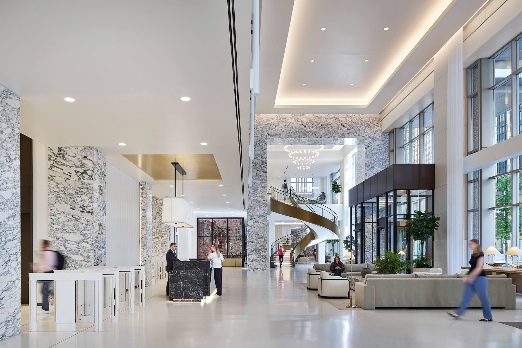 Lobby reception photo showing check-in, entrance, and a large spiral staircase.