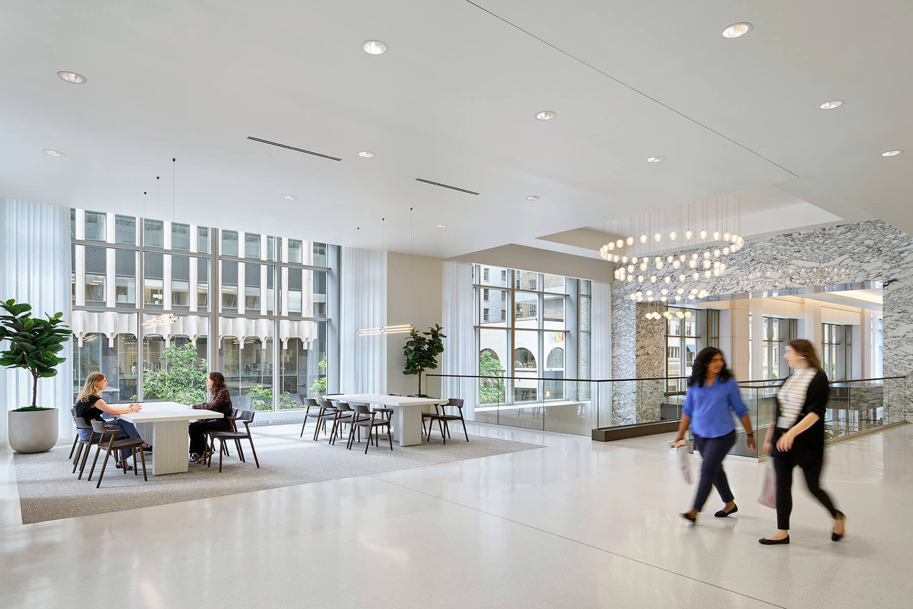 Large open lobby with breakout seating and floor to ceiling windows.