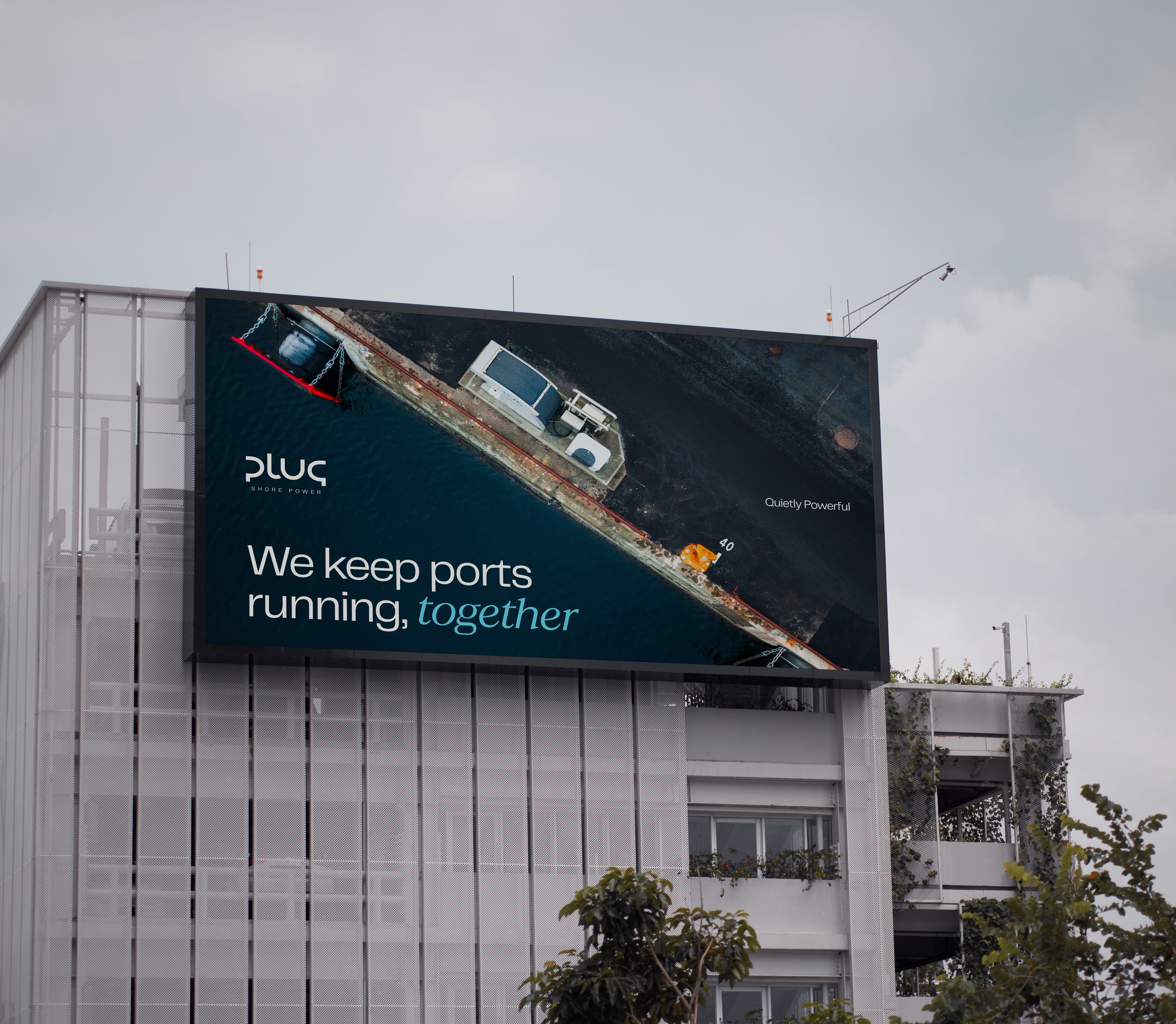 Plug billboard on a building: We keep ports running, together