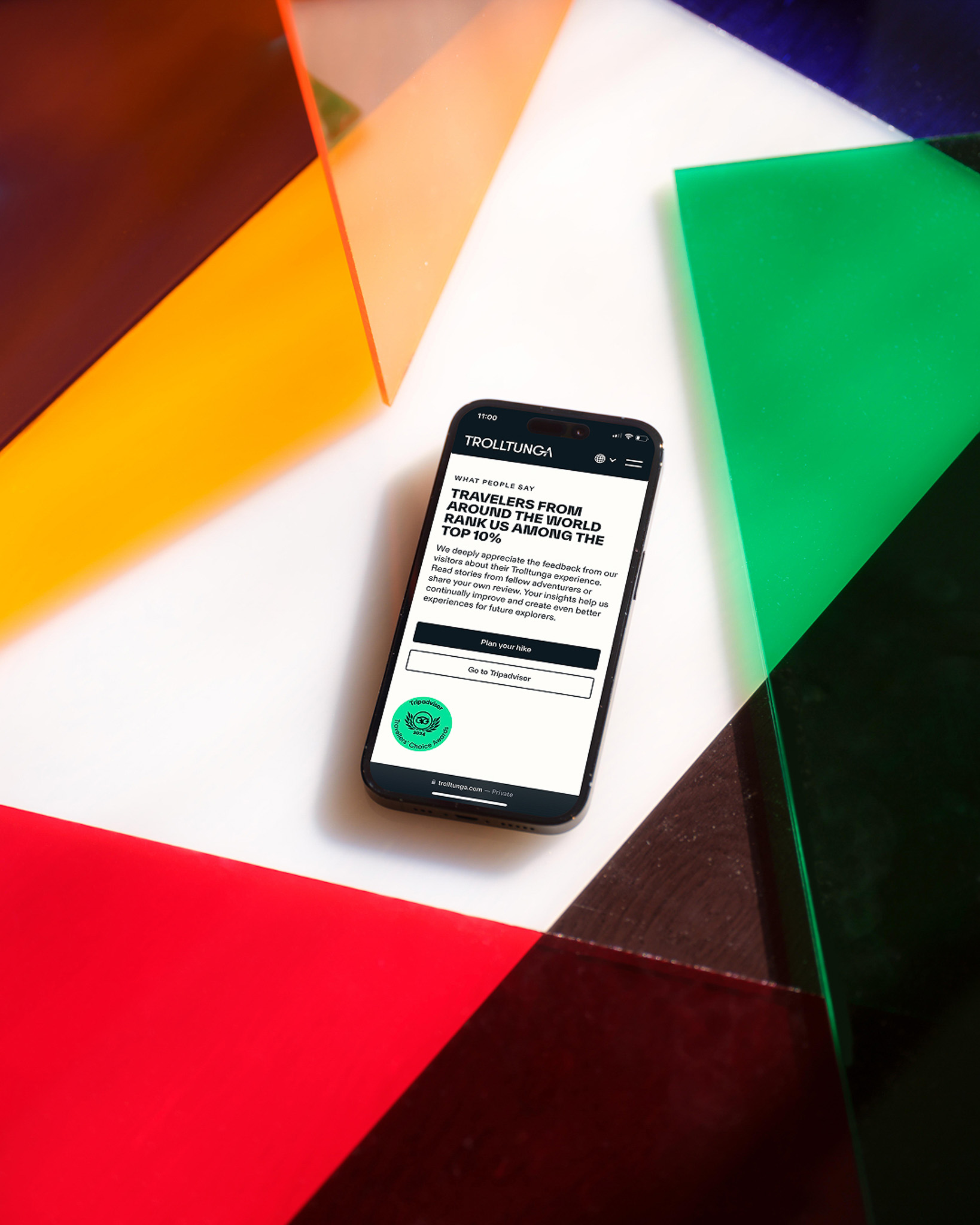 The Trolltunga website on a phone against a colourful background