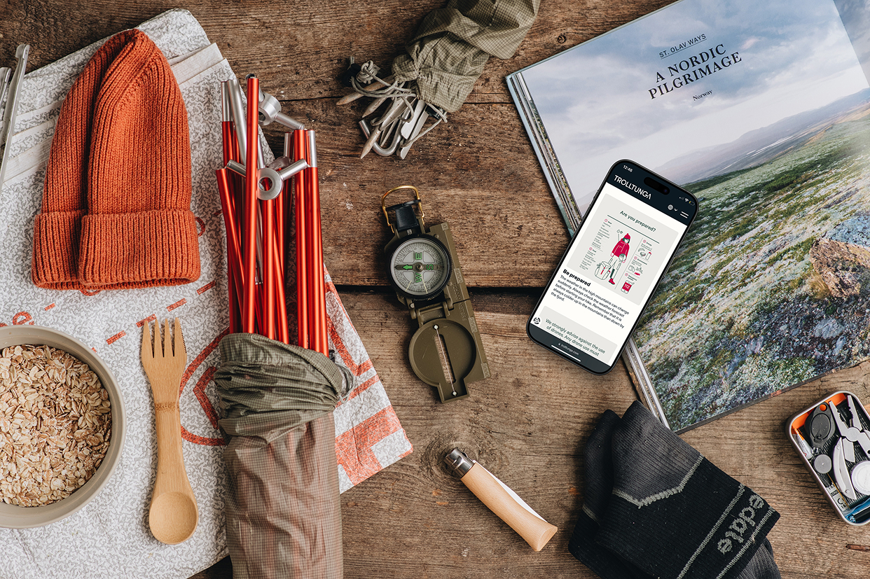 Hiking gear and the Trolltunga website on a phone