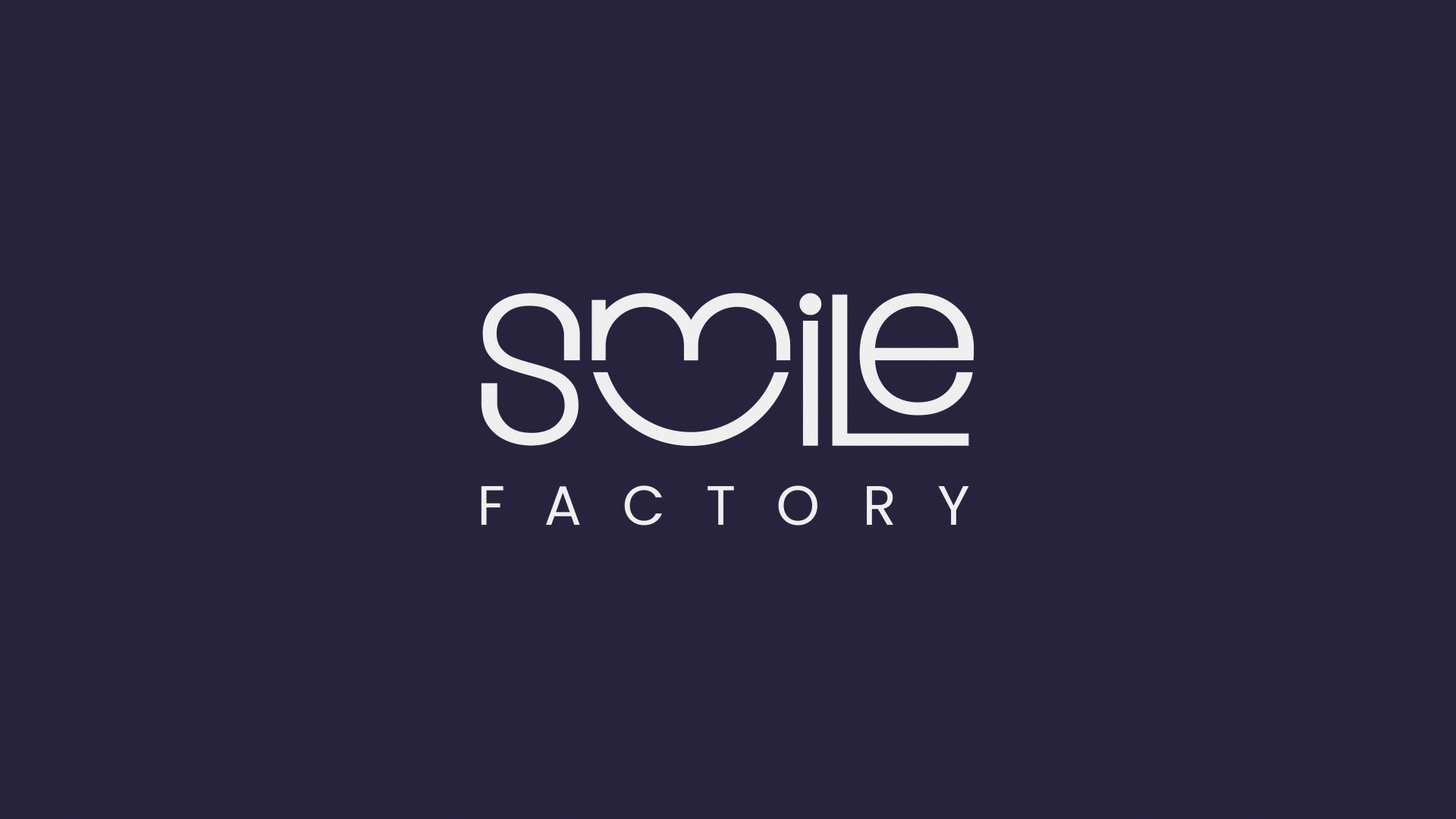 The Smile Factory logo on a dark background