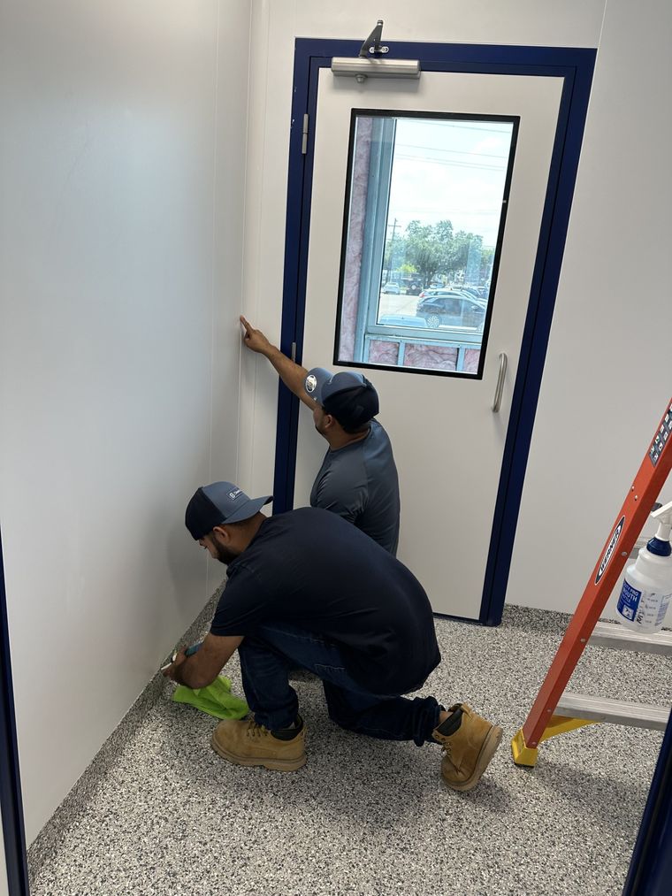 Technician servicing a cleanroom vision panel