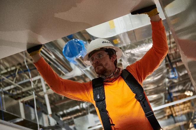 CleanSpace tradesperson installing overhead systems
