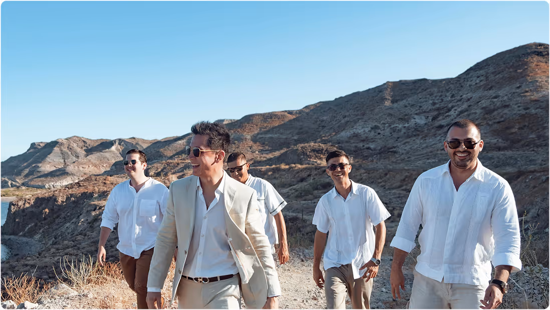 five men walk in the desert wearing white shirts and sunglasses on a bachelor party planned on Pilot