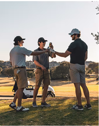 three men dressed in golf attire cheer each other during a break in play