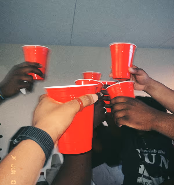 Red solo cups coming together for a toast during a bachelor party planned on Pilot