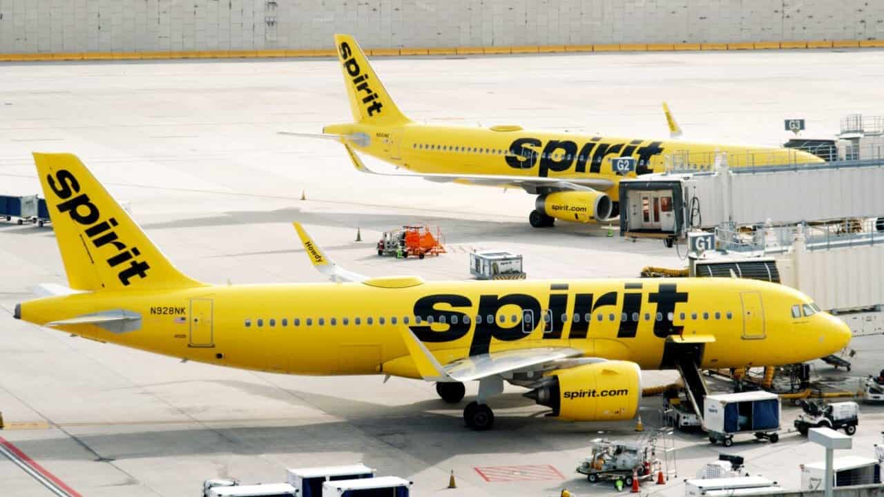 Spirit airline airplanes sitting out on the tarmac at the airport