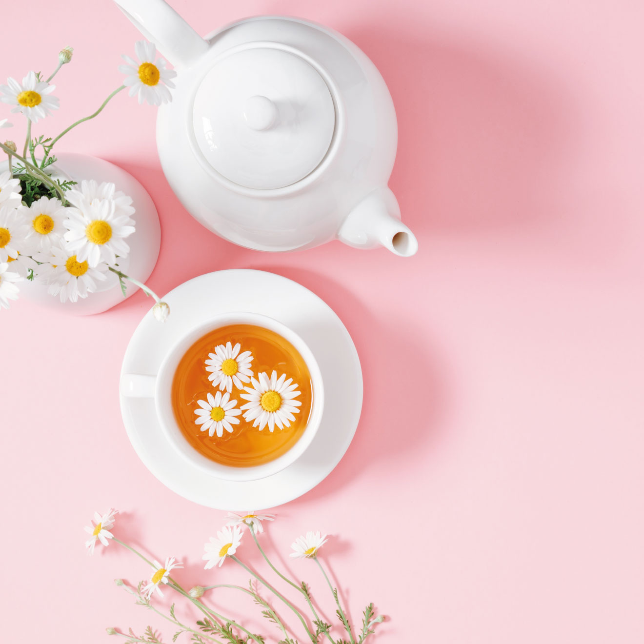 White tea set on pink background