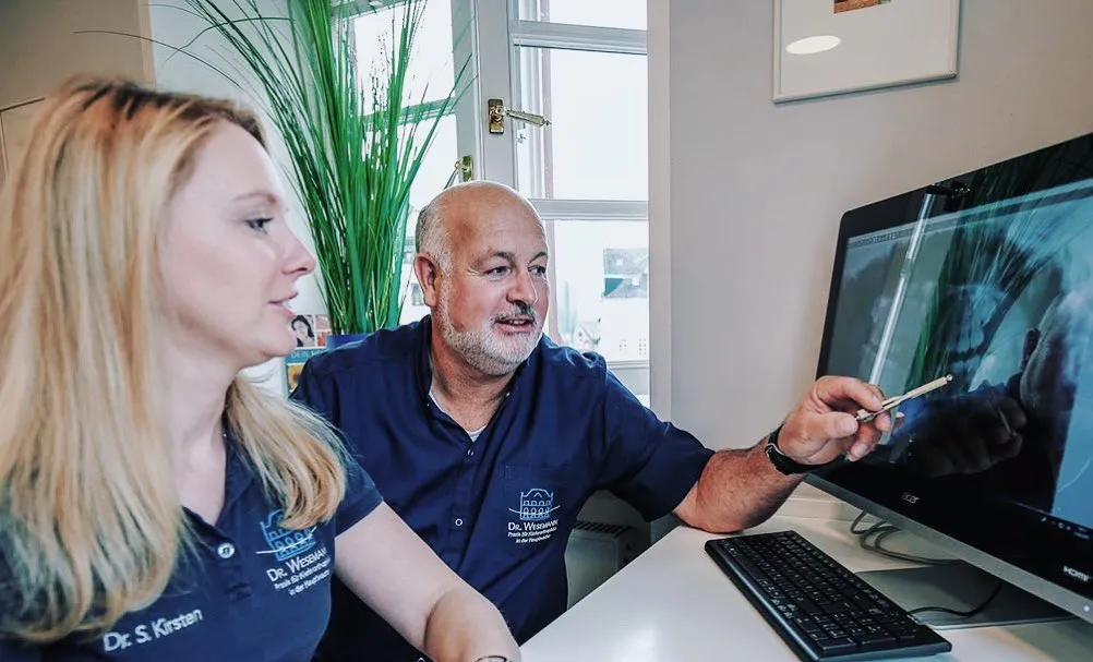 Doctors looking at a Computer