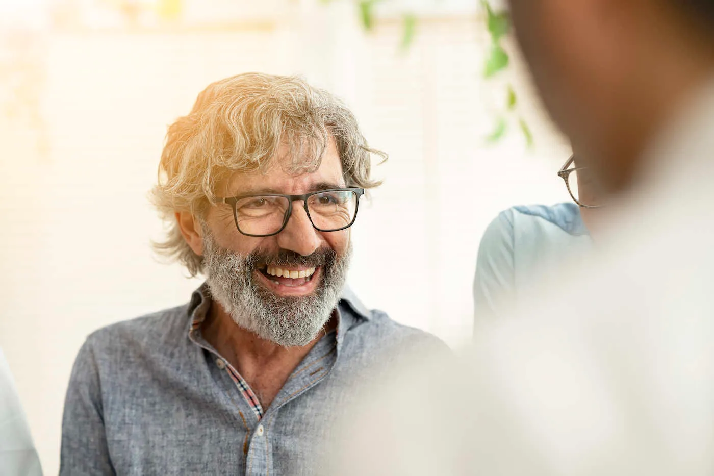 senior-businessman-smiling-with-work-group