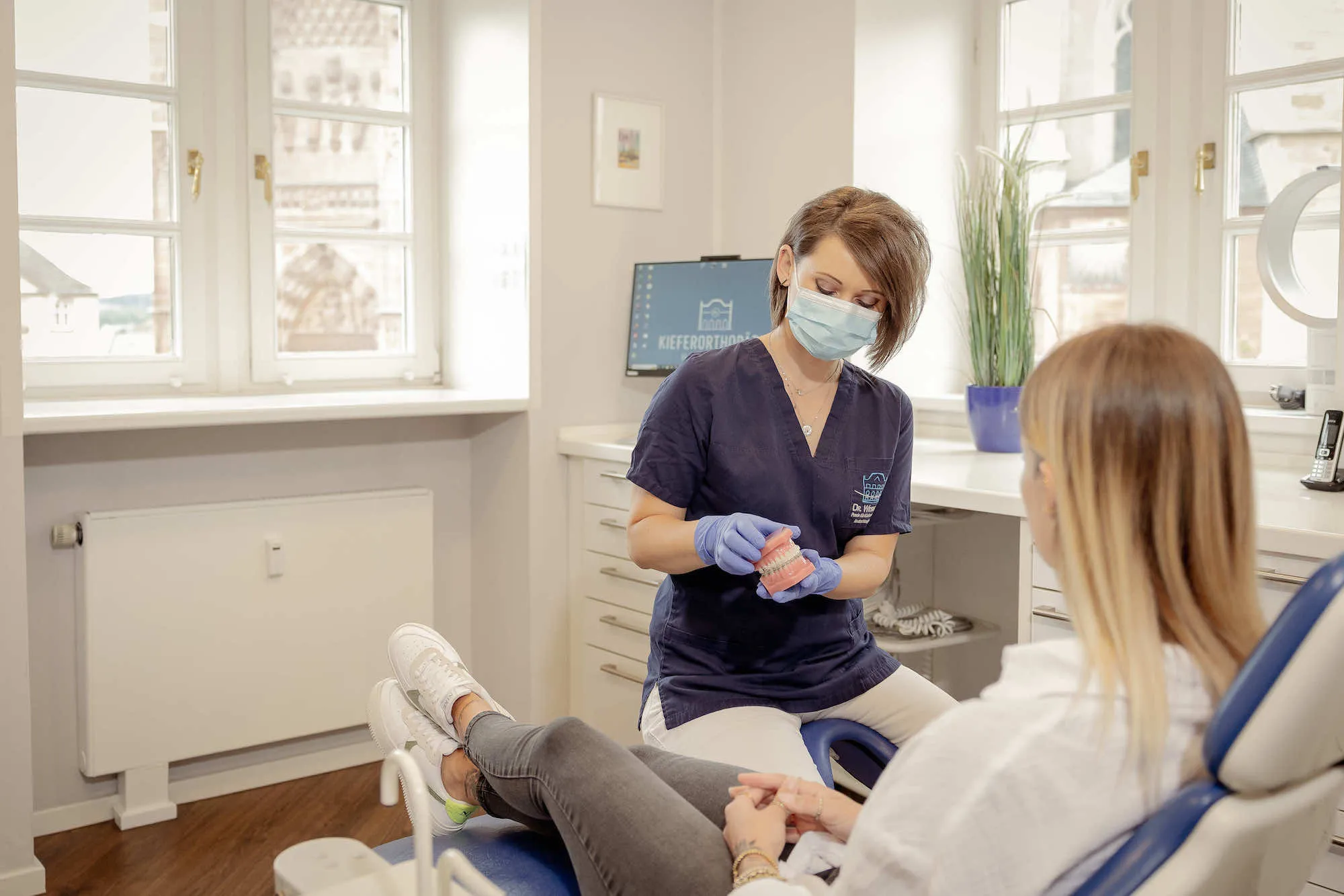 a woman getting her teeth checked by a dentist