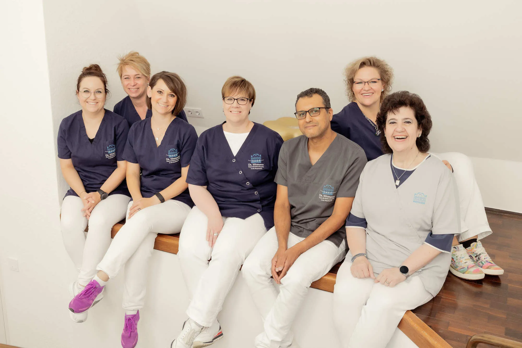 a group of people sitting next to each other on a bench