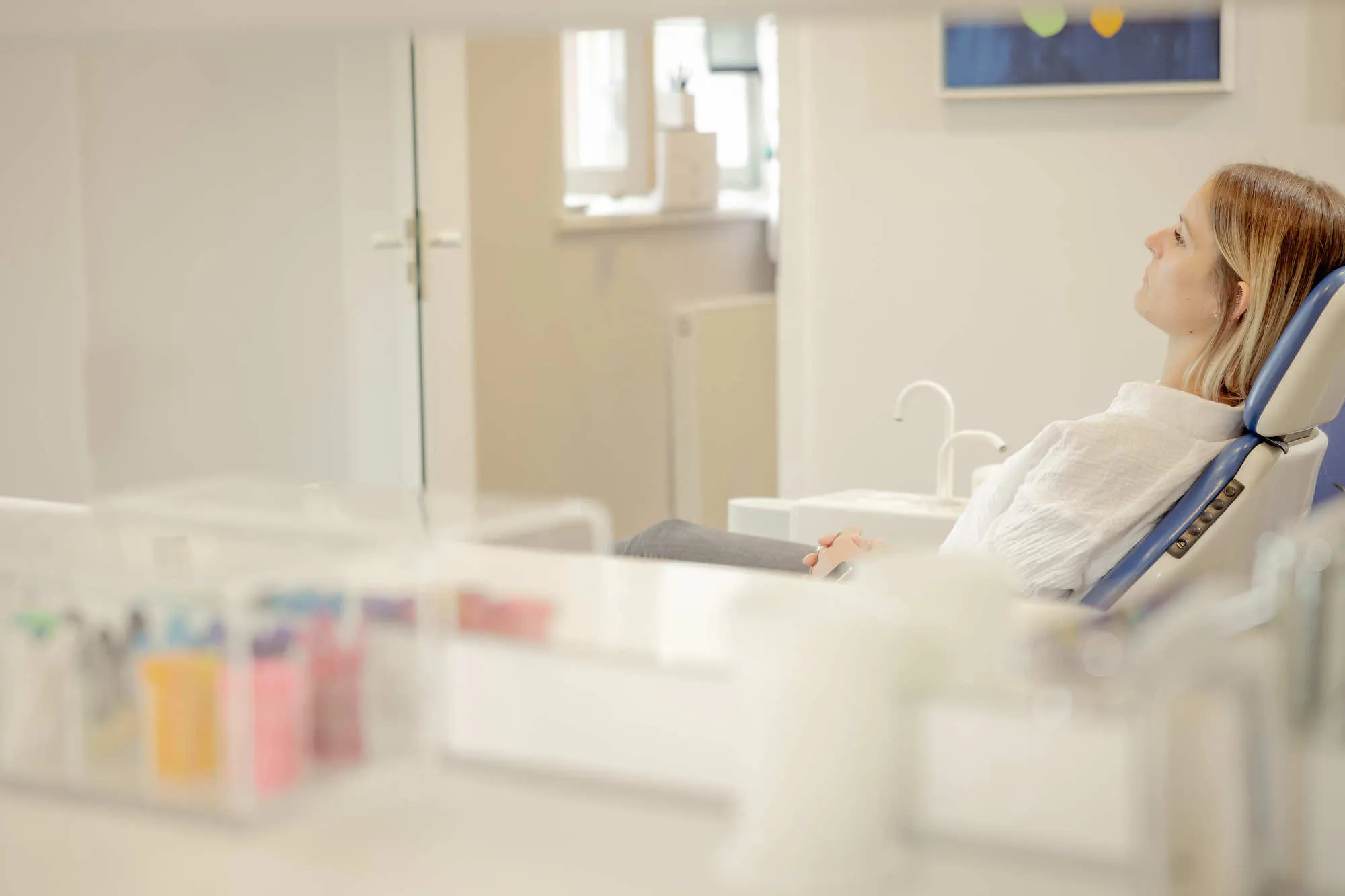 a woman sitting in a chair in front of a mirror