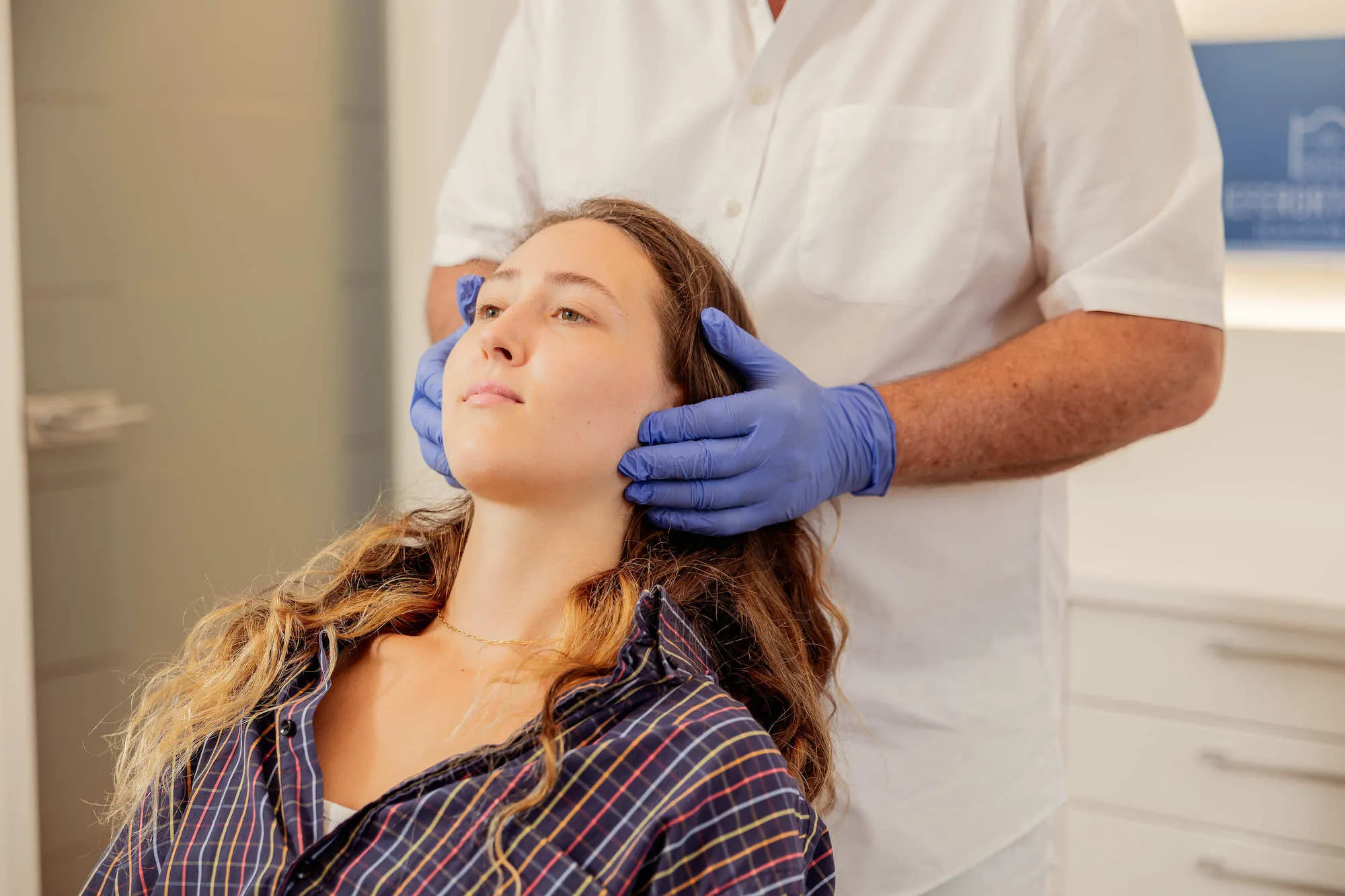 a woman getting her hair cut by a hair stylist