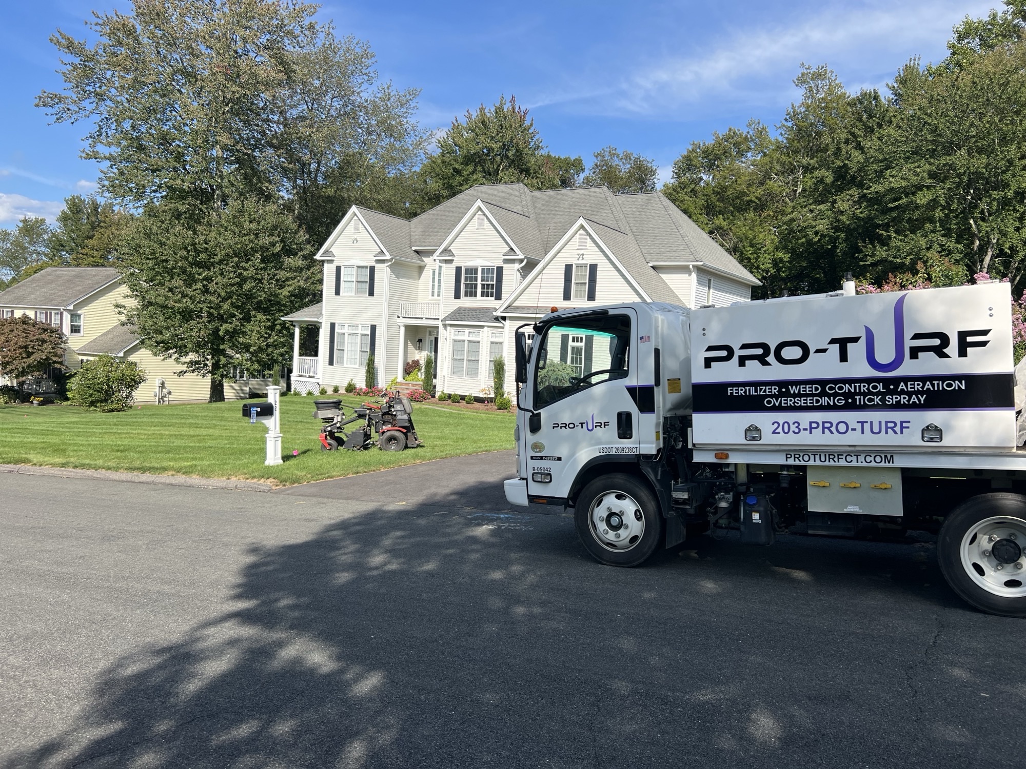 Pro-Turf aerator and truck on a Newtown, CT lawn during fall core aeration