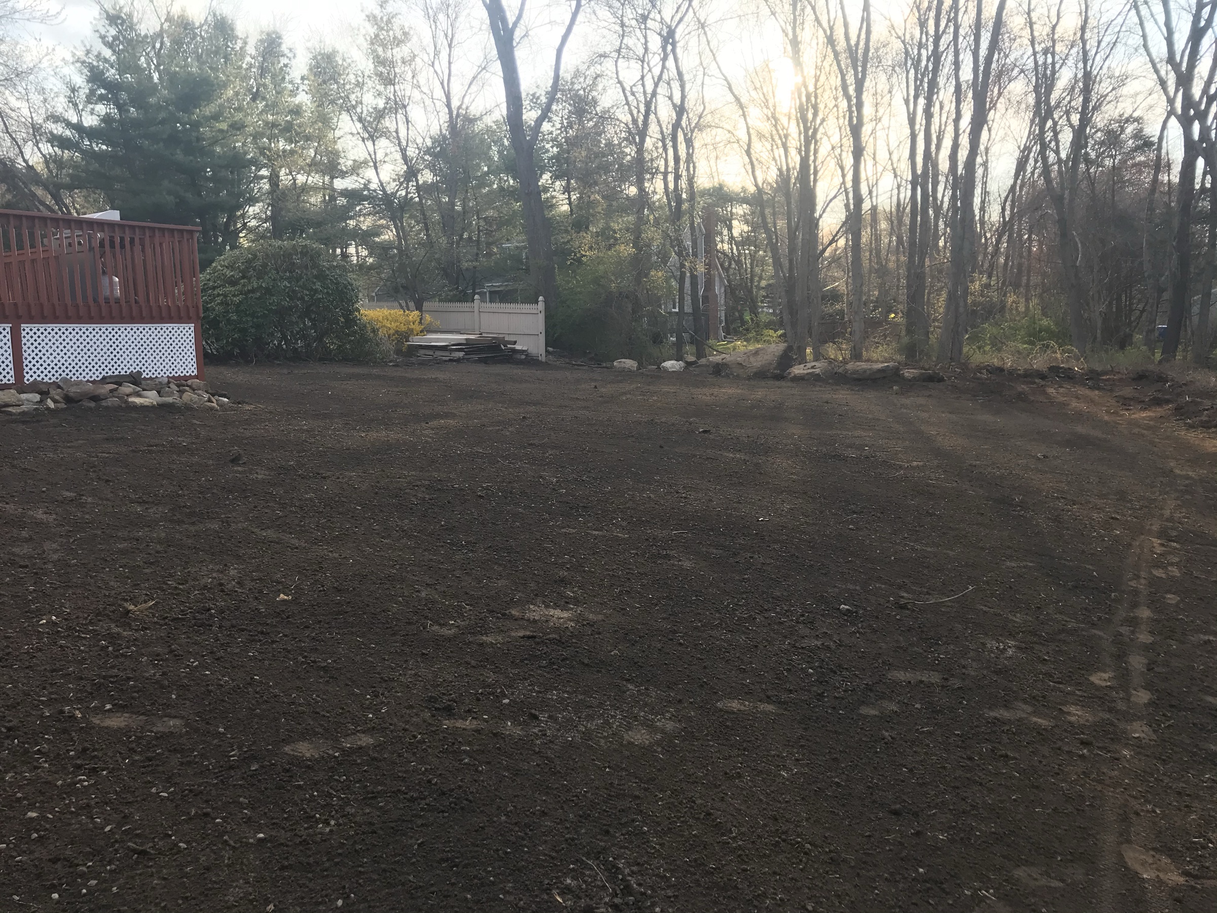 Finish grading a Connecticut lawn — tractor box blade levelling soil away from the house