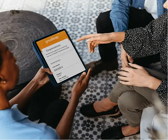 A person showing benefits of financing to a couple using his tablet